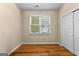 Bedroom showcases hardwood floors, neutral walls, and a window with bright natural light at 130 Augusta Dr, Peachtree City, GA 30269