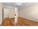 Bedroom features hardwood floors, ceiling fan, neutral walls, and entrances to bathroom and closet at 130 Augusta Dr, Peachtree City, GA 30269