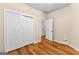 Bedroom with hardwood floors features a closet and white painted trim with tan walls at 130 Augusta Dr, Peachtree City, GA 30269