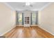 Bedroom features hardwood floors, a ceiling fan, and two windows with curtains at 130 Augusta Dr, Peachtree City, GA 30269