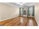 Bedroom features hardwood floors, a ceiling fan, and two windows with curtains at 130 Augusta Dr, Peachtree City, GA 30269