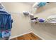 Walk-in closet features built-in shelving and hardwood flooring at 130 Augusta Dr, Peachtree City, GA 30269