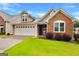 Charming home featuring a well-maintained lawn and two-car garage at 130 Augusta Dr, Peachtree City, GA 30269