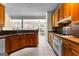 Traditional kitchen with wooden cabinets, tile floors, and stainless steel appliances at 130 Augusta Dr, Peachtree City, GA 30269