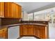 Kitchen featuring wooden cabinets, granite countertops, and tile flooring at 130 Augusta Dr, Peachtree City, GA 30269