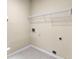 Empty laundry room with hookups and overhead shelving at 130 Augusta Dr, Peachtree City, GA 30269