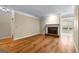Spacious living room with hardwood floors and a cozy brick fireplace at 130 Augusta Dr, Peachtree City, GA 30269