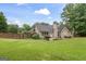 Lush backyard with a spacious lawn and mature trees, offering a serene outdoor retreat at 200 Pine Tree Ln, Mcdonough, GA 30252