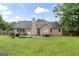 Manicured backyard featuring an outdoor dining area at 200 Pine Tree Ln, Mcdonough, GA 30252