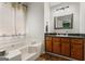 Bathroom featuring soaking tub, wood vanity, and ample lighting at 200 Pine Tree Ln, Mcdonough, GA 30252