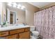 Bathroom with a single sink vanity, mirror and patterned shower curtain at 200 Pine Tree Ln, Mcdonough, GA 30252