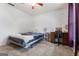 Bedroom with a ceiling fan, desk, and plush carpet at 200 Pine Tree Ln, Mcdonough, GA 30252