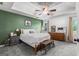 Spacious bedroom with tray ceiling, fan, large bed, and stylish furnishings at 200 Pine Tree Ln, Mcdonough, GA 30252