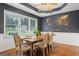 Stylish dining room featuring a wooden table, decorative wall art, and natural lighting at 200 Pine Tree Ln, Mcdonough, GA 30252