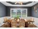 Bright dining room featuring wood table, six chairs, large window, and stylish décor for Gathering gatherings at 200 Pine Tree Ln, Mcdonough, GA 30252