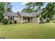 Beautiful home exterior with lush lawn, front porch and rocking chairs at 200 Pine Tree Ln, Mcdonough, GA 30252