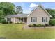 Charming home with well-manicured lawn, rocking chairs on the porch, and swing at 200 Pine Tree Ln, Mcdonough, GA 30252