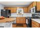 Well-lit kitchen with wooden cabinetry, stainless steel appliances, island, and ample counter space at 200 Pine Tree Ln, Mcdonough, GA 30252