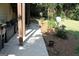 Backyard with walkway, flowerbeds, mature landscaping, and outdoor decor at 9342 Carillon Ct, Jonesboro, GA 30236