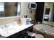 Bathroom vanity with white counter and dark cabinets next to soaking tub at 9342 Carillon Ct, Jonesboro, GA 30236