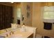 This bathroom features a single vanity and framed mirror with decorative striped wallpaper at 9342 Carillon Ct, Jonesboro, GA 30236