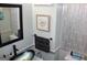 Well-lit bathroom showcasing modern fixtures, unique wall paneling and stylish decor at 9342 Carillon Ct, Jonesboro, GA 30236