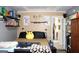 Bedroom with a neutral color scheme, unique decor and a glimpse into another room at 9342 Carillon Ct, Jonesboro, GA 30236
