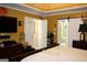 Spacious bedroom with tray ceilings, hardwood floors, and barn style bathroom door at 9342 Carillon Ct, Jonesboro, GA 30236
