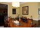 Dining room featuring a large wooden table with elegant decor, adjacent to an open kitchen at 9342 Carillon Ct, Jonesboro, GA 30236