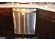Stainless steel dishwasher nestled among the custom wood cabinetry and countertops at 9342 Carillon Ct, Jonesboro, GA 30236