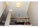 View of the foyer with a decorative chandelier, hardwood floors, and a wooden railing overlooking the entrance at 9342 Carillon Ct, Jonesboro, GA 30236
