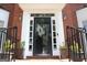 Close up view of the black front door featuring windows, lights, and a wreath at 9342 Carillon Ct, Jonesboro, GA 30236