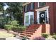 The red brick front entrance features a black front door with side windows and black railing at 9342 Carillon Ct, Jonesboro, GA 30236