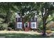 Inviting two-story brick home framed by lush greenery and mature trees at 9342 Carillon Ct, Jonesboro, GA 30236