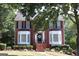Charming two-story brick home with meticulous landscaping, showcasing a welcoming entrance at 9342 Carillon Ct, Jonesboro, GA 30236