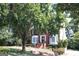 A view of the home with mature trees in the front yard at 9342 Carillon Ct, Jonesboro, GA 30236
