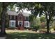 Two-story brick home with well-manicured lawn and mature trees offering curb appeal at 9342 Carillon Ct, Jonesboro, GA 30236
