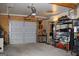 Organized garage with shelving, tools, and a side entrance for easy access at 9342 Carillon Ct, Jonesboro, GA 30236