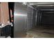 Garage interior featuring paneled doors, refrigerator, and open space at 9342 Carillon Ct, Jonesboro, GA 30236