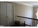 Hallway with closet, dark wood floors, and a decorative chandelier at 9342 Carillon Ct, Jonesboro, GA 30236