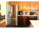 Modern kitchen with stainless steel refrigerator and beautiful wood cabinetry at 9342 Carillon Ct, Jonesboro, GA 30236
