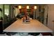 Spacious kitchen island with light countertops, open shelving, and convenient access to dining area at 9342 Carillon Ct, Jonesboro, GA 30236