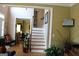 View of a living room and staircase area, with the television mounted on the wall at 9342 Carillon Ct, Jonesboro, GA 30236