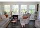 Bright and cozy sunroom featuring large windows, a fireplace, and comfortable seating at 9342 Carillon Ct, Jonesboro, GA 30236