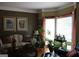 Cozy living room with sofa, large windows, and potted plants at 9342 Carillon Ct, Jonesboro, GA 30236