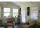 Relaxing sitting room boasts natural light and comfortable chairs at 9342 Carillon Ct, Jonesboro, GA 30236