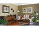 Comfortable living room with a piano, sofa, and hardwood floors at 9342 Carillon Ct, Jonesboro, GA 30236