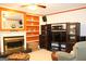 Spacious living room featuring a cozy fireplace and custom built in shelving at 9342 Carillon Ct, Jonesboro, GA 30236