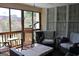 Inviting screened porch featuring chairs and outdoor views at 9342 Carillon Ct, Jonesboro, GA 30236