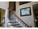 Interior view of the staircase with wooden handrail and black iron spindles at 9342 Carillon Ct, Jonesboro, GA 30236